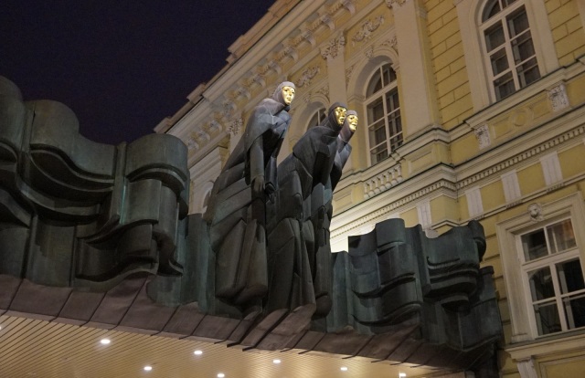 I went for a walk at night to see some of Vilnius in the dark.  I saw this interesting statue on the entrance of a theater.